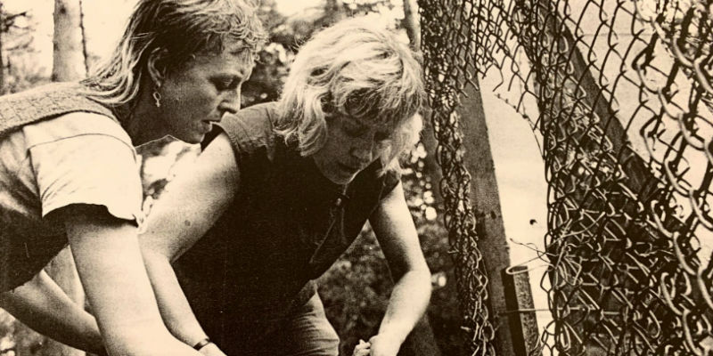 Greenham Common women cutting the wire on a fence